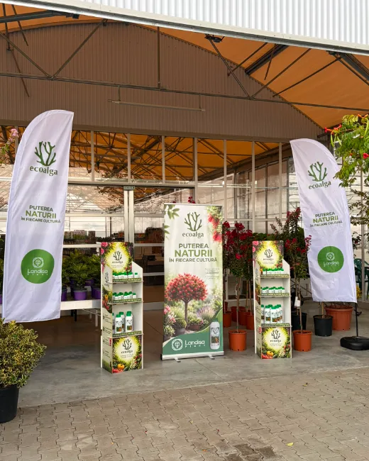 Banderas verticales y expositores de Ecoalga a la entrada del área de venta de plantas